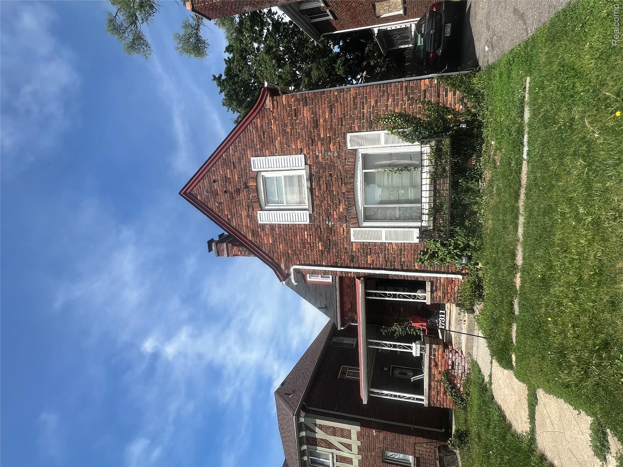 17311 Santa Rosa Drive Detroit, MI 48221 - Photo 1 of 89 Brick exterior featuring a gabled roofline and white window shutters