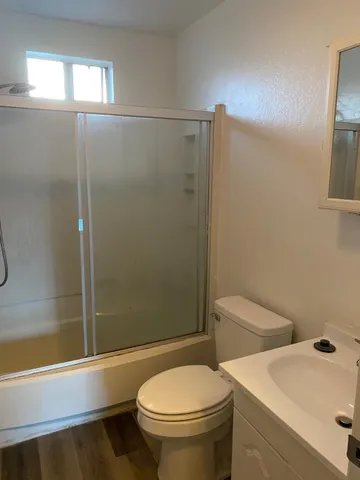 a bathroom with a toilet and a shower