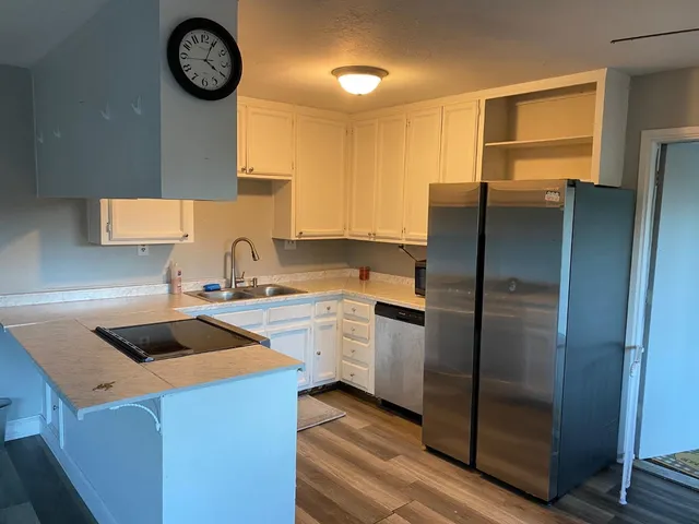 a kitchen with a refrigerator and a sink