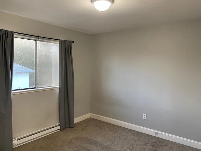 an empty room with a mirror