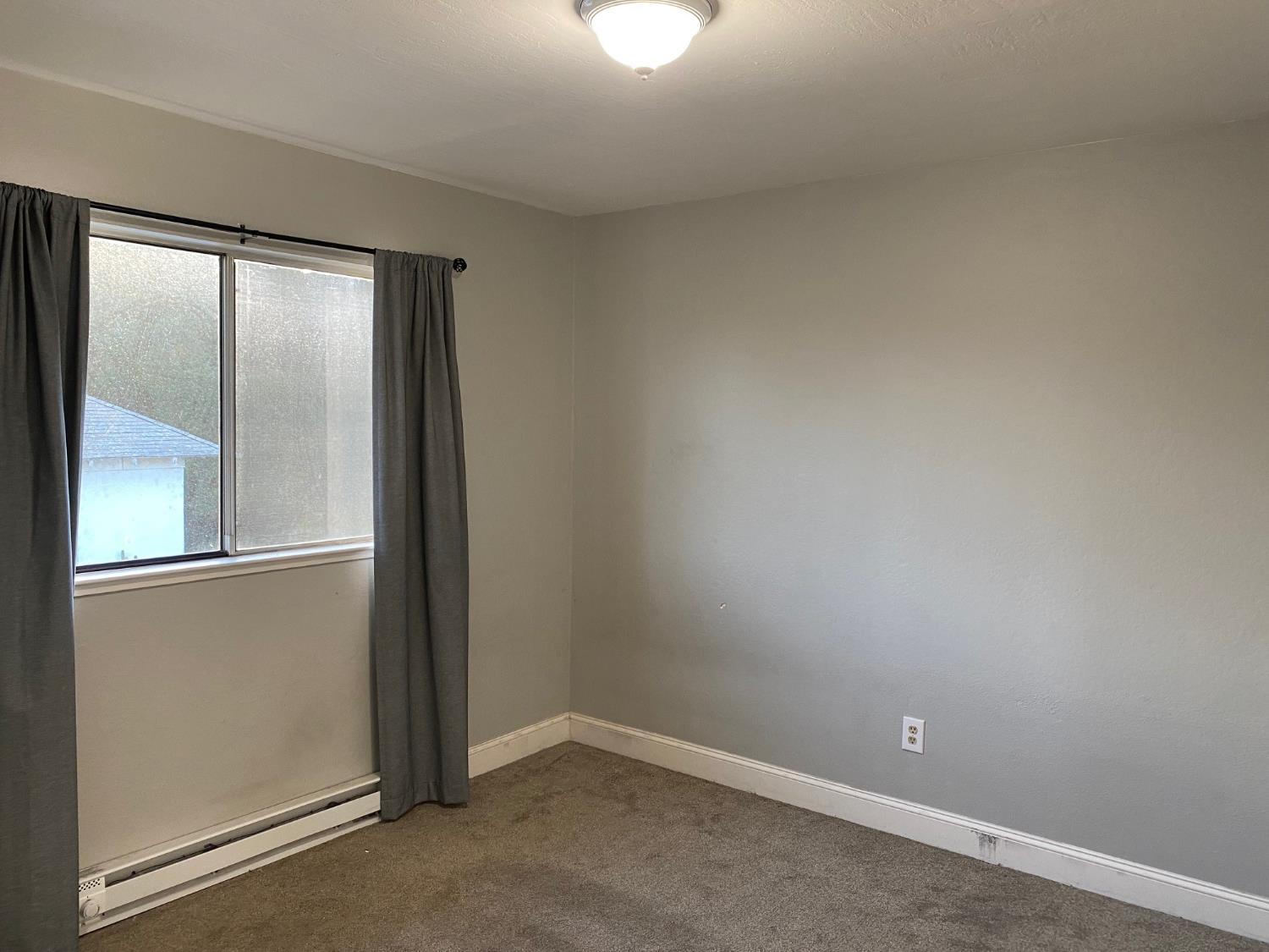 17 Raggio Road, Unit 4 Jackson, CA 95642 - Photo 9 of 11 an empty room with a mirror