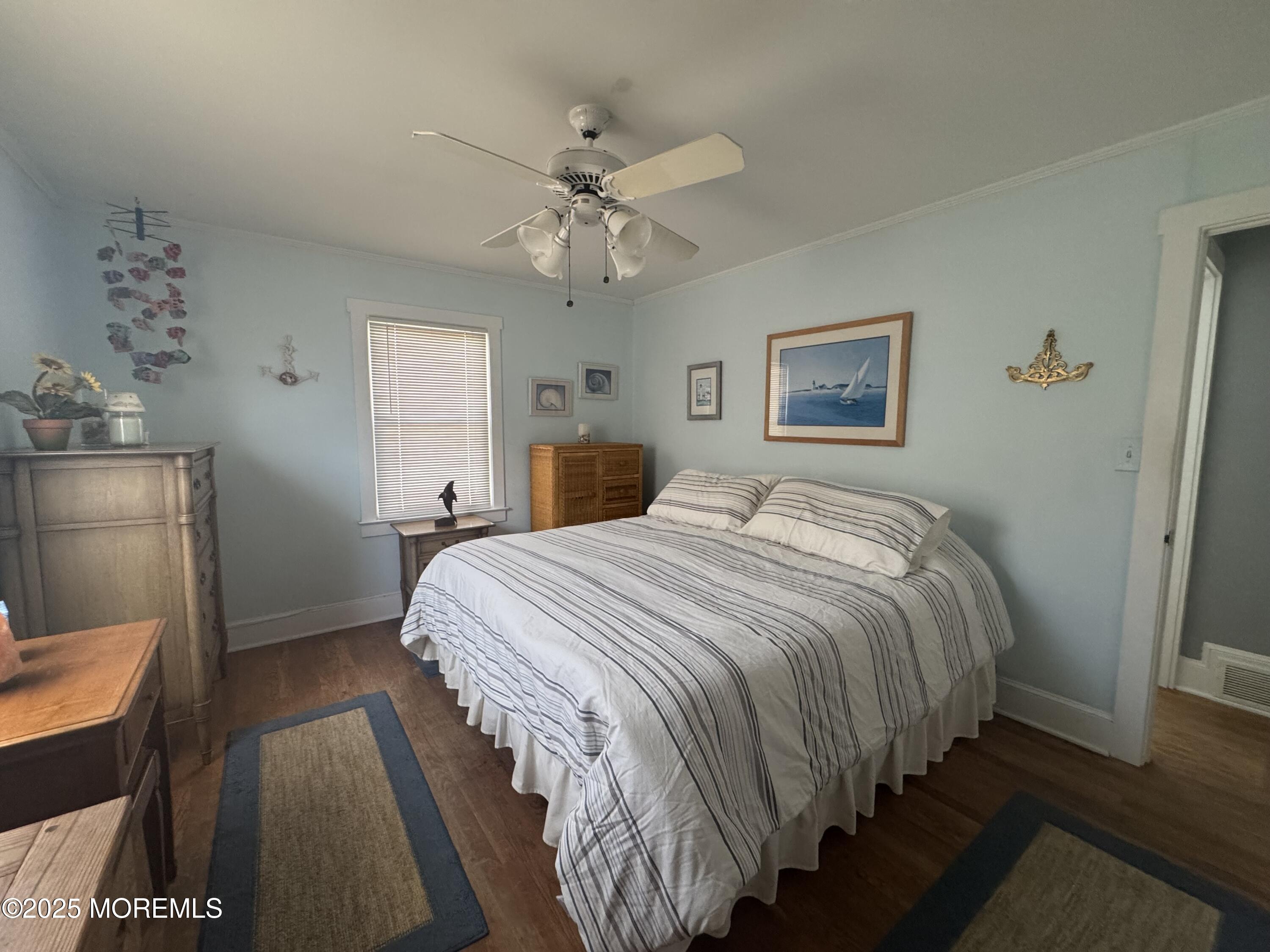 115 Boardwalk Point Pleasant Beach, NJ 08742 - Photo 20 of 23 a bedroom with a bed and a chandelier