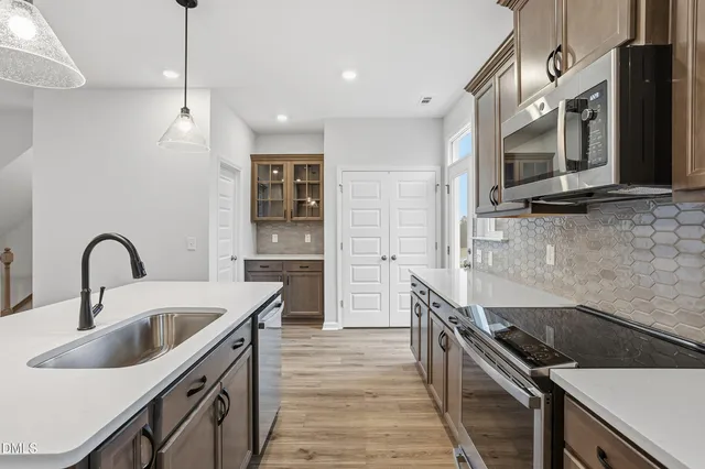 a kitchen with a sink stove and cabinets