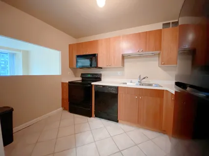 a kitchen with stainless steel appliances a refrigerator stove and sink