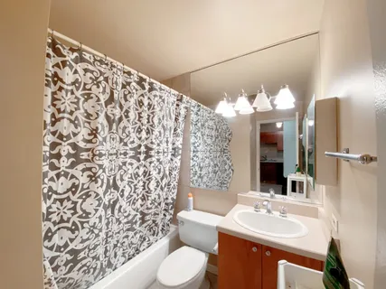 a bathroom with a sink toilet and shower
