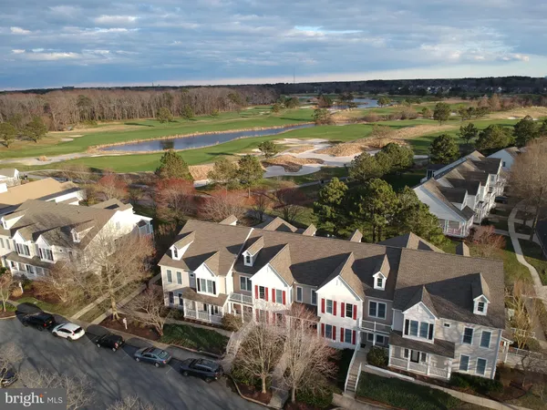 an aerial view of residential houses with outdoor space and street view