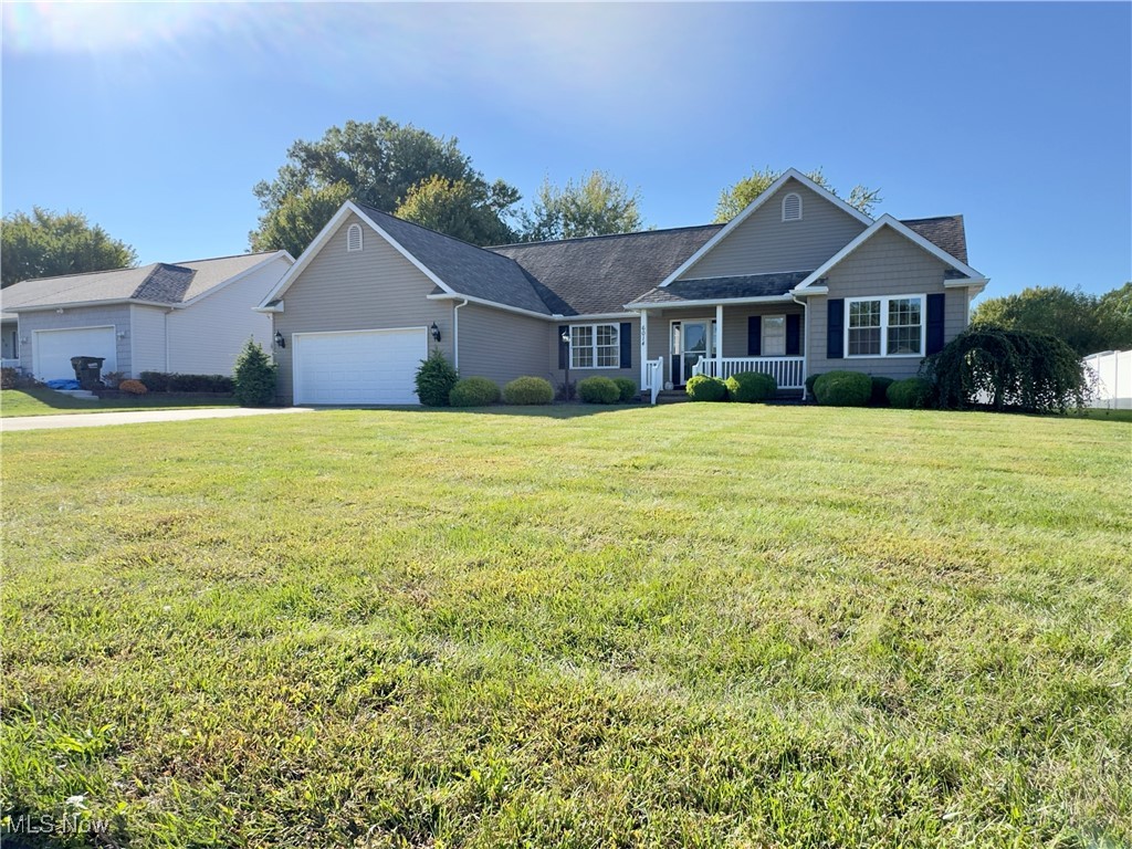 6014 Wentworth Road Southwest Canton, OH 44706 - Photo 2 of 22 Ranch-style home featuring a porch, a front lawn, and a garage