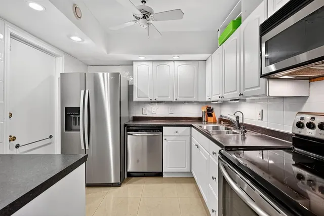 a kitchen with a sink stainless steel appliances and cabinets