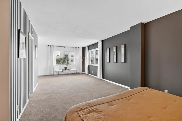 a bedroom with a large bed and a window