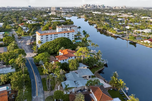an aerial view of lake residential house with swimming pool and ocean view