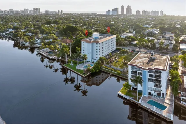 an aerial view of residential houses with outdoor space and seating