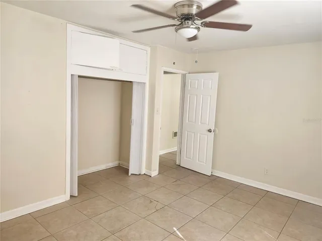 an empty room with a ceiling fan