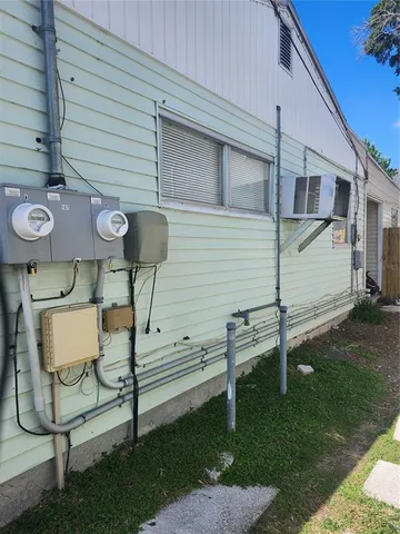 a view of backyard with a chair under a large window
