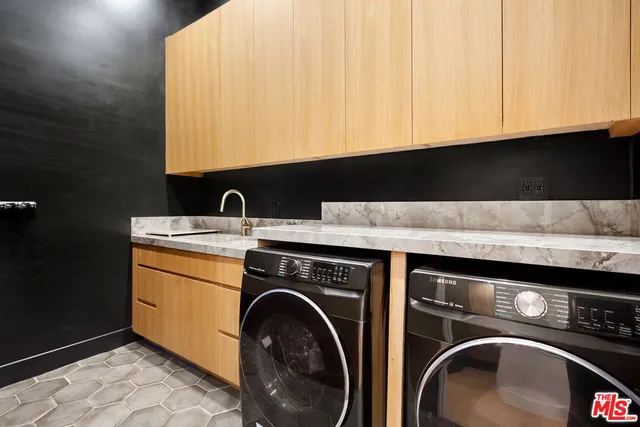 a living room with a flat screen tv a rug and a window