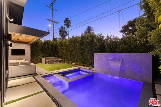 a swimming pool with outdoor seating and yard