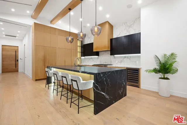 a living room with furniture potted plant and a large window