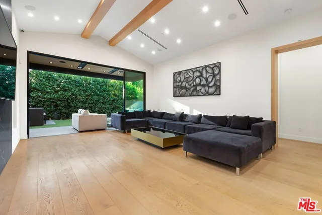 a view of a dining room with furniture and a chandelier
