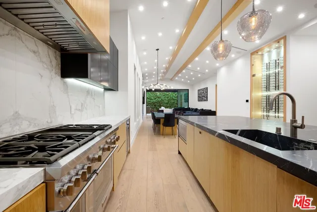 a bathroom with a granite countertop sink and mirror