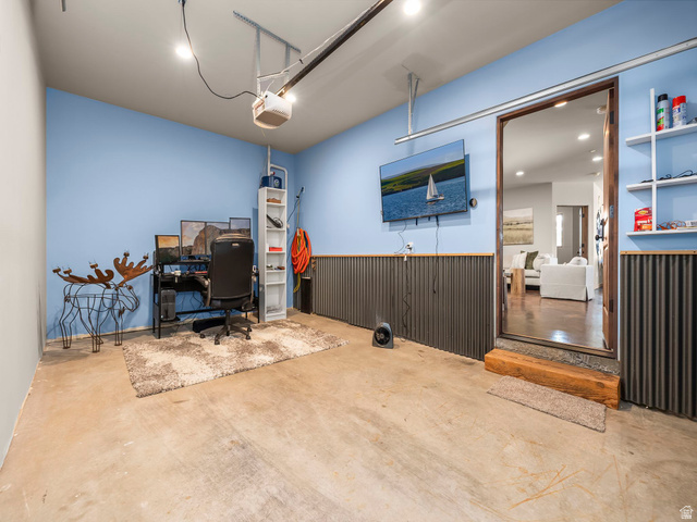 22677 East Snowbird Drive, Unit 47 Helper, UT 84526 - Photo 33 of 43 Home office featuring a garage, concrete floors, recessed lighting, wainscoting, and wooden walls