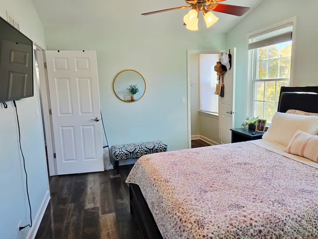 a bedroom with a bed and a chandelier