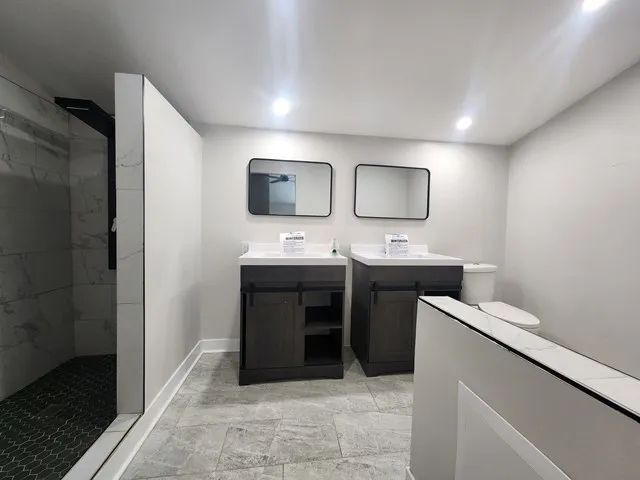 a bathroom with a double vanity sink and mirror