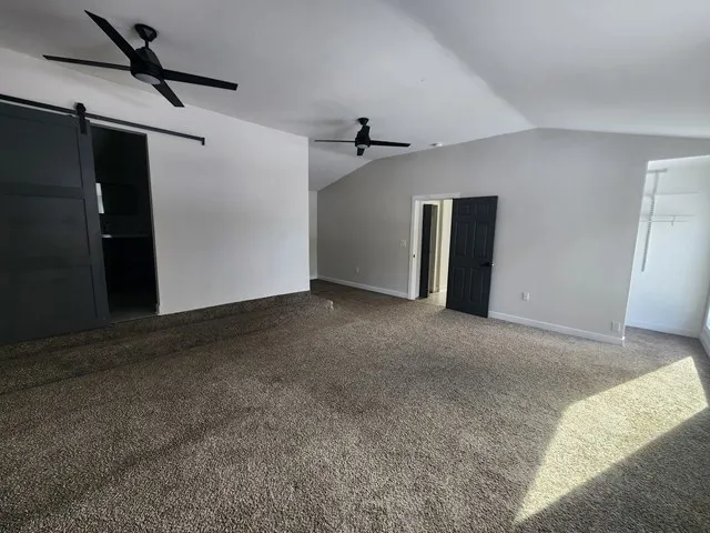 a view of empty room with ceiling fan