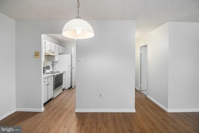 a view of a kitchen cabinets and wooden floor