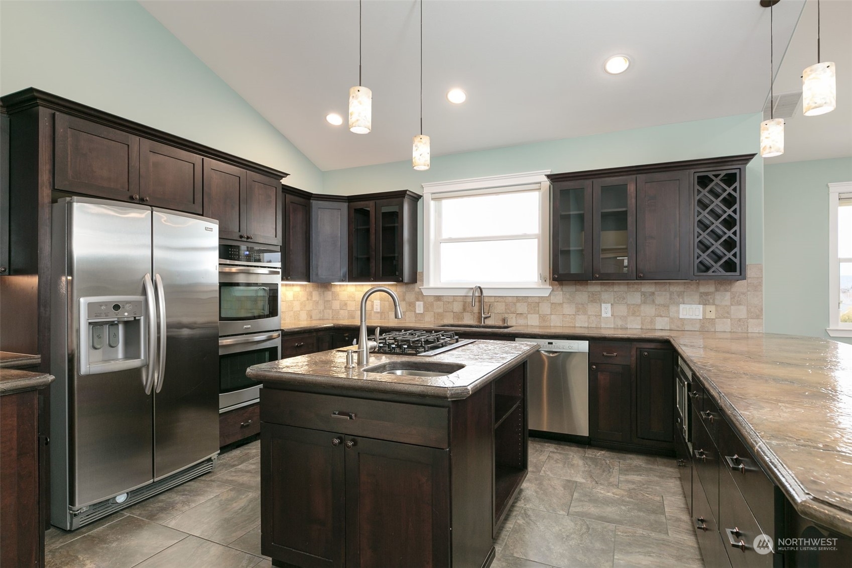 12708 Summitview Ext Road Yakima, WA 98908 - Photo 11 of 30 a kitchen with kitchen island granite countertop stainless steel appliances a sink dishwasher a refrigerator a stove a kitchen island and cabinets