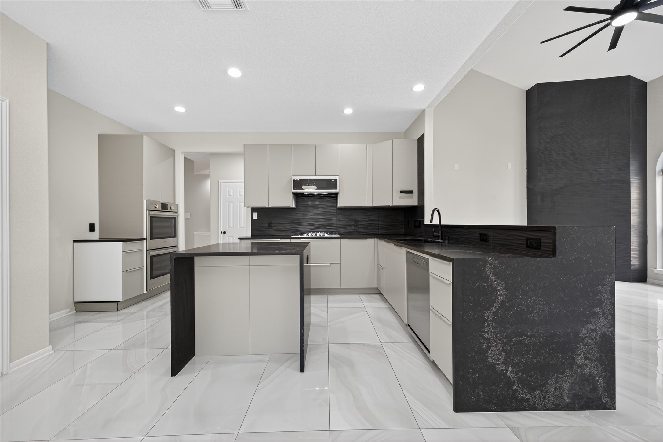 1003 Alp Springs Lane Spring, TX 77373 - Photo 11 of 43 a large kitchen with stainless steel appliances kitchen island granite countertop a refrigerator a sink and white cabinets