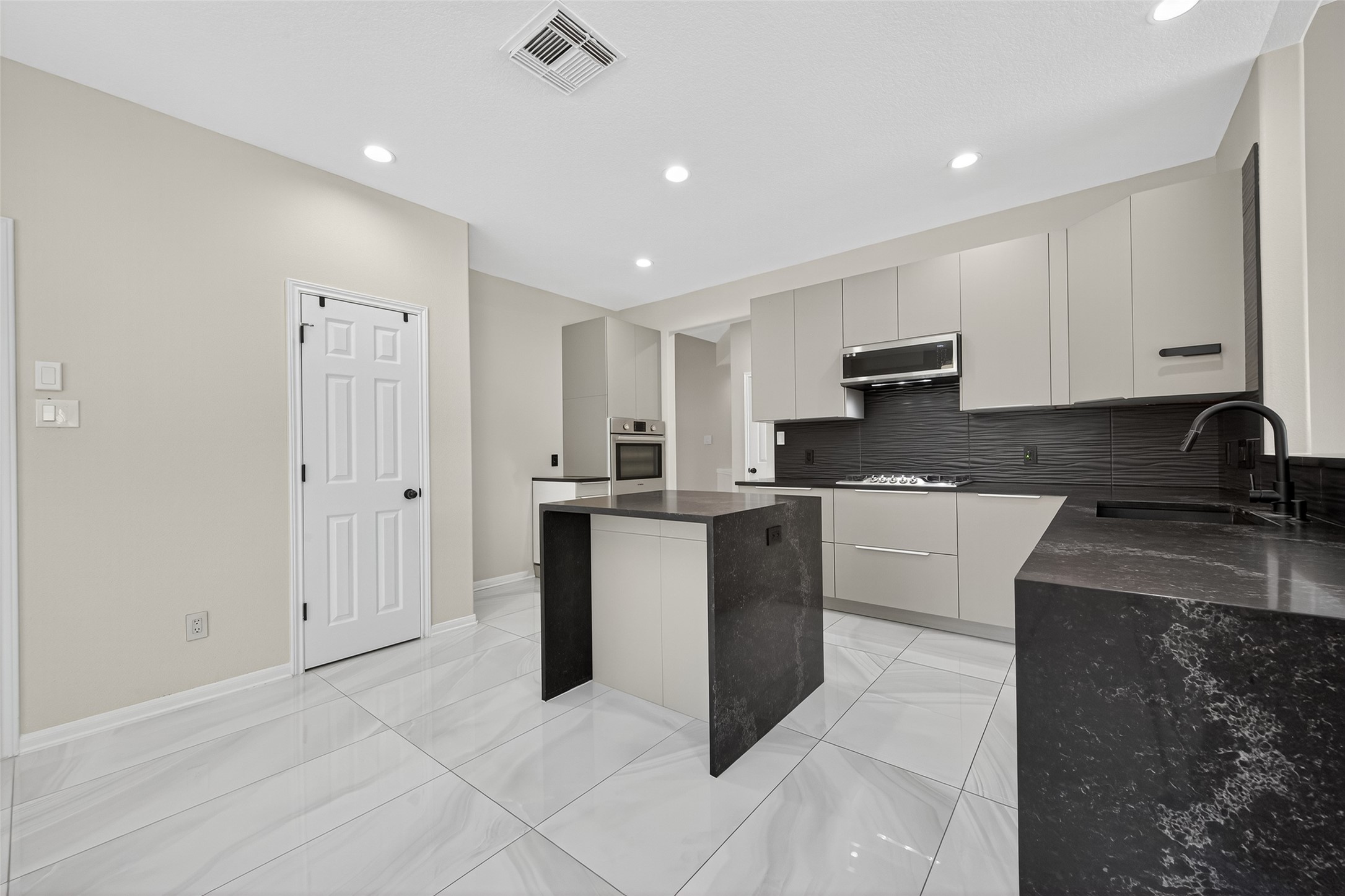 1003 Alp Springs Lane Spring, TX 77373 - Photo 12 of 43 a kitchen with granite countertop a refrigerator a sink and white cabinets