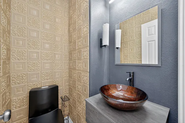 a bathroom with a toilet and a mirror