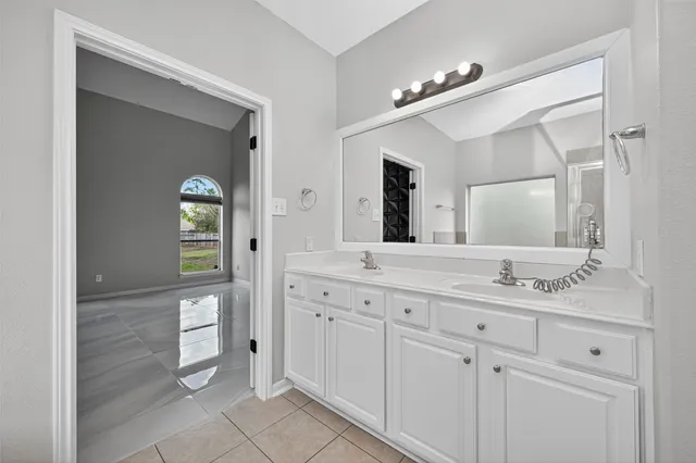 a spacious bathroom with a granite countertop sink mirror and a