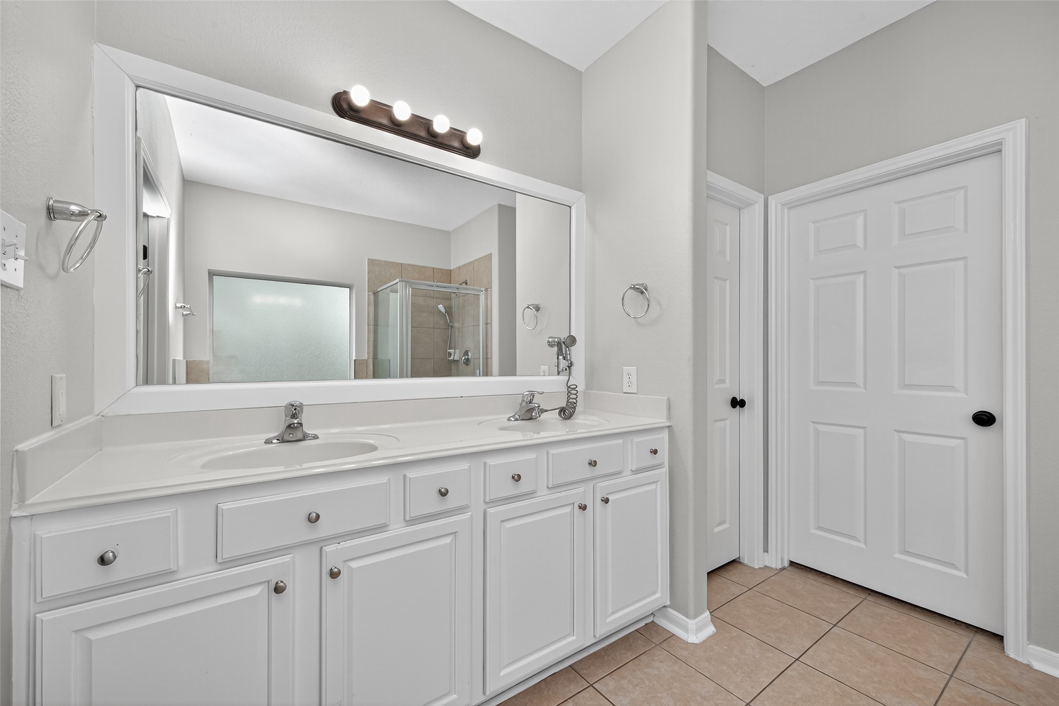 1003 Alp Springs Lane Spring, TX 77373 - Photo 27 of 43 a bathroom with a double vanity sink and a mirror