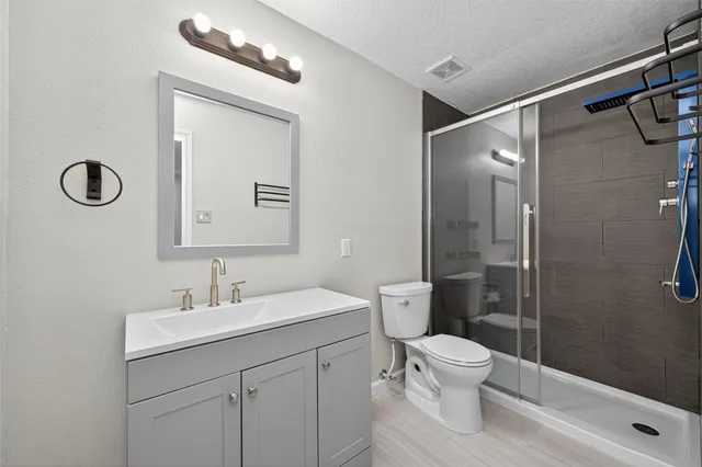 a bathroom with a toilet sink and shower