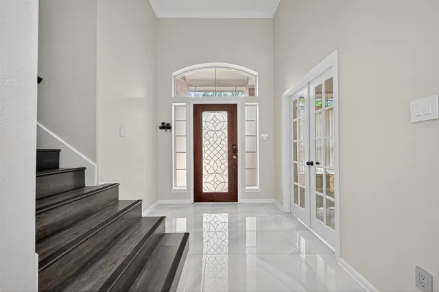 a view of a hallway with wooden floor and entryway