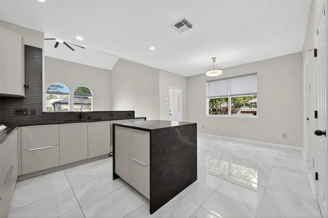 a kitchen with cabinets and window