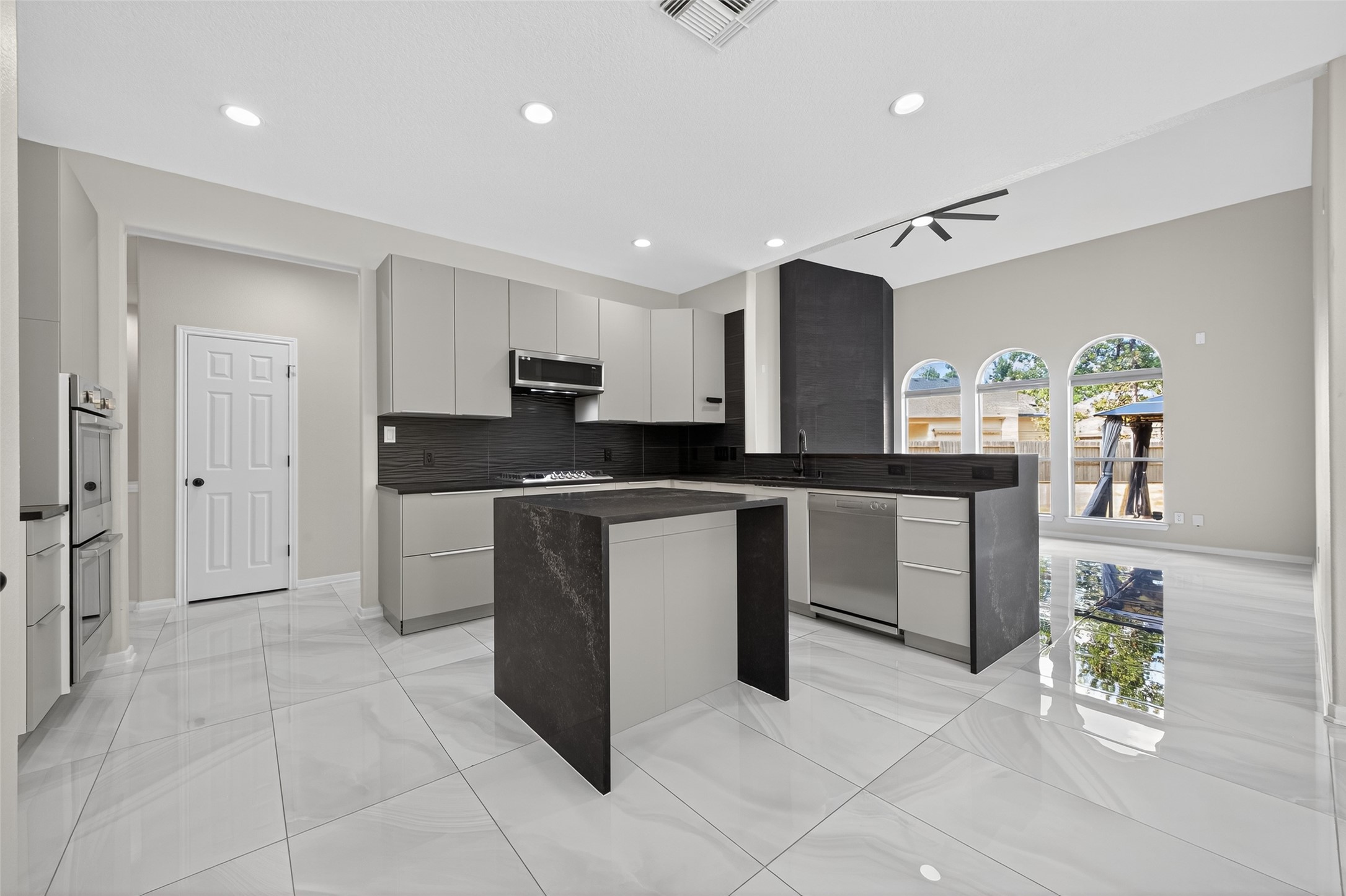 1003 Alp Springs Lane Spring, TX 77373 - Photo 10 of 43 a kitchen with a sink a counter top space and stainless steel appliances