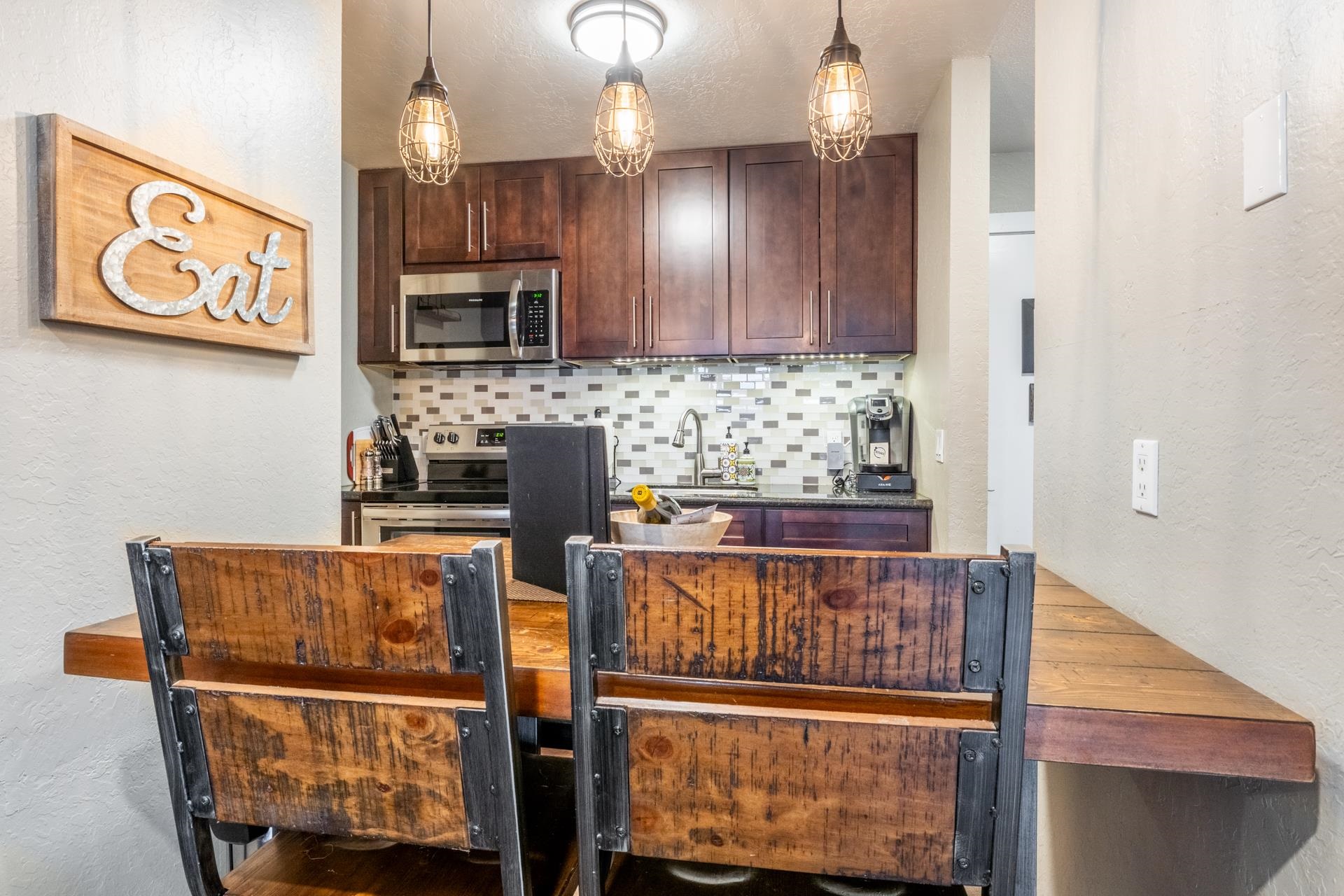 2289 Sierra Nevada Road, Unit F4 Mammoth Lakes, CA 93546 - Photo 10 of 22 a kitchen with stainless steel appliances granite countertop a refrigerator and a stove