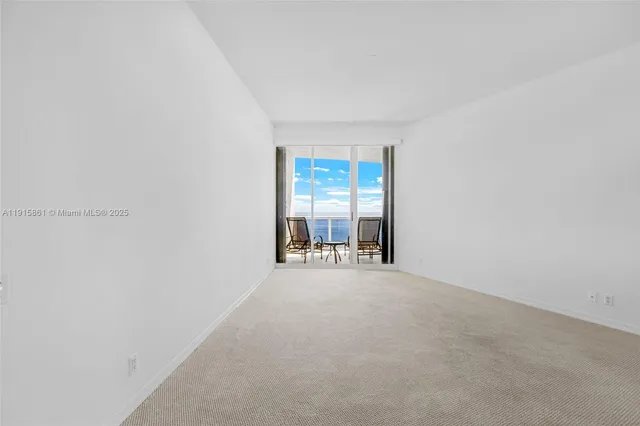 an empty room with furniture and windows