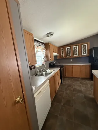 a kitchen with sink cabinets and window