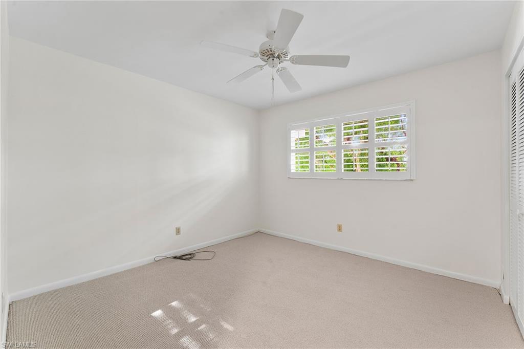 37 High Point Circle East, Unit 307 Naples, FL 34103 - Photo 17 of 20 an empty room with a window and a ceiling fan