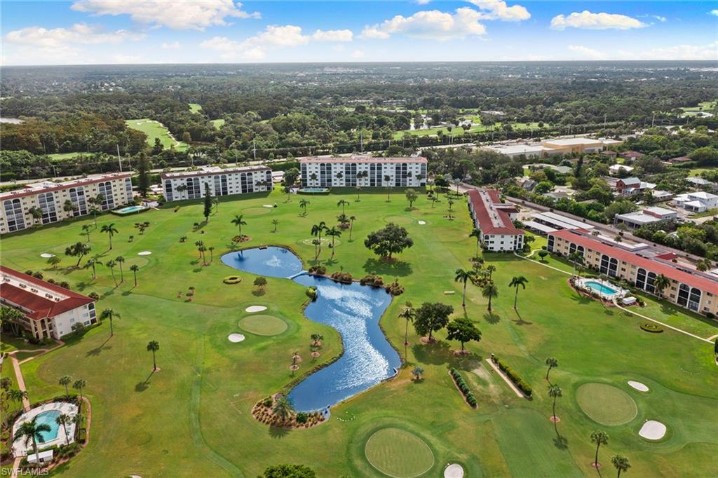37 High Point Circle East, Unit 307 Naples, FL 34103 - Photo 5 of 20 an aerial view of a swimming pool a yard and mountain view in back
