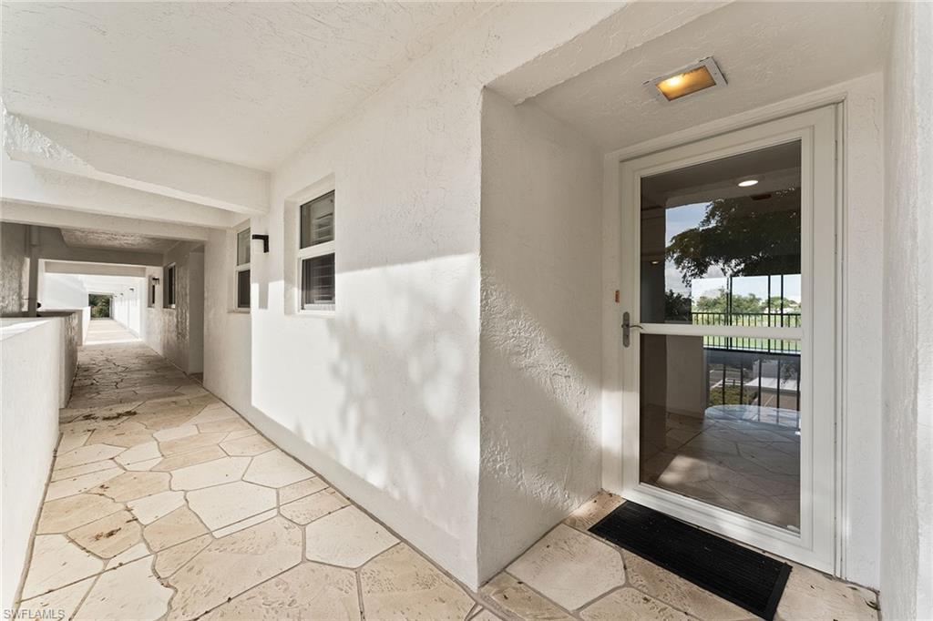 37 High Point Circle East, Unit 307 Naples, FL 34103 - Photo 6 of 20 a view of a hallway view with staircase