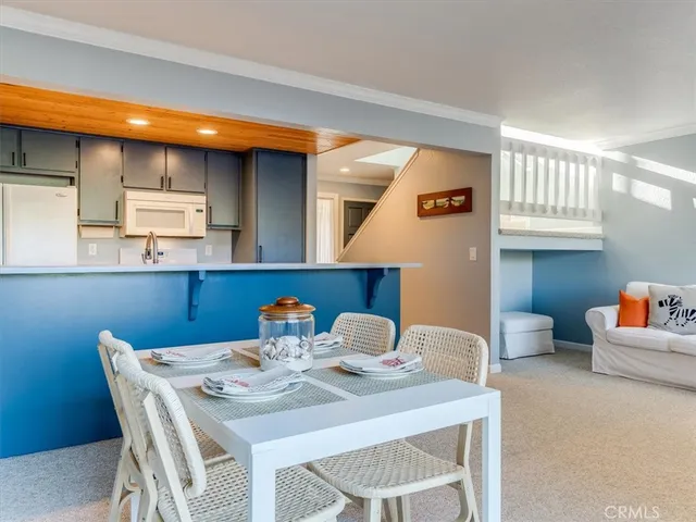 a kitchen with stainless steel appliances wooden cabinets and a refrigerator