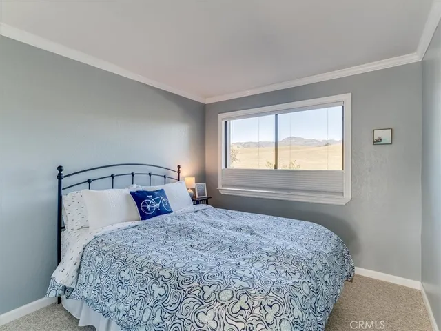 a bedroom with a large bed and a lamp on table
