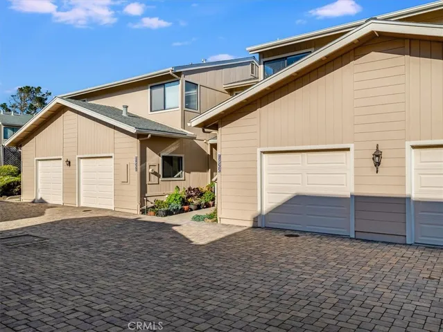 a house with potted plants in front of door