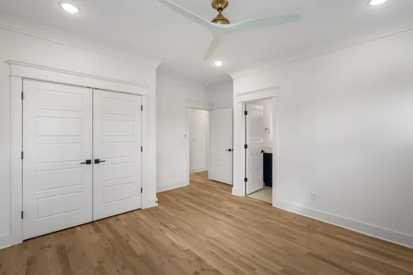 an empty room with fan and entryway