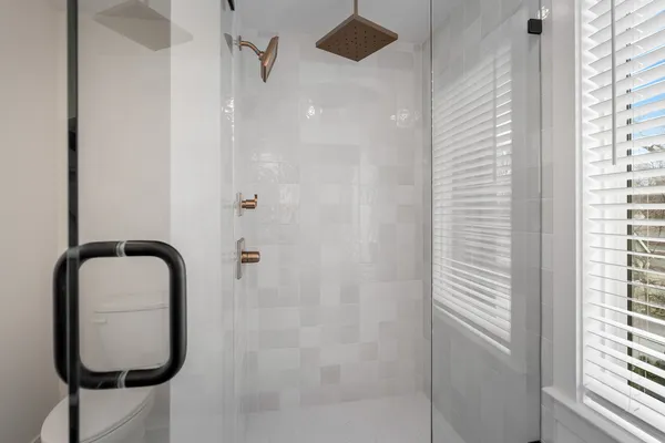 a bathroom with a bathtub and shower