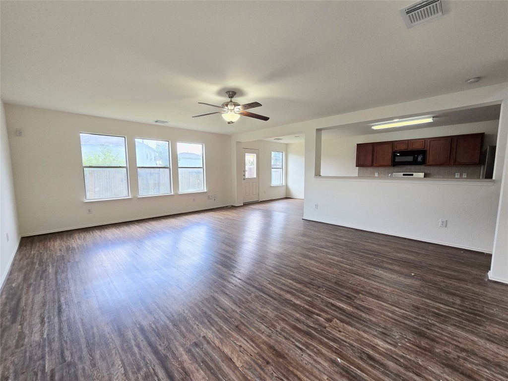 22911 Twisting Maple Court Spring, TX 77373 - Photo 12 of 37 a view of a livingroom with wooden floor and a ceiling fan