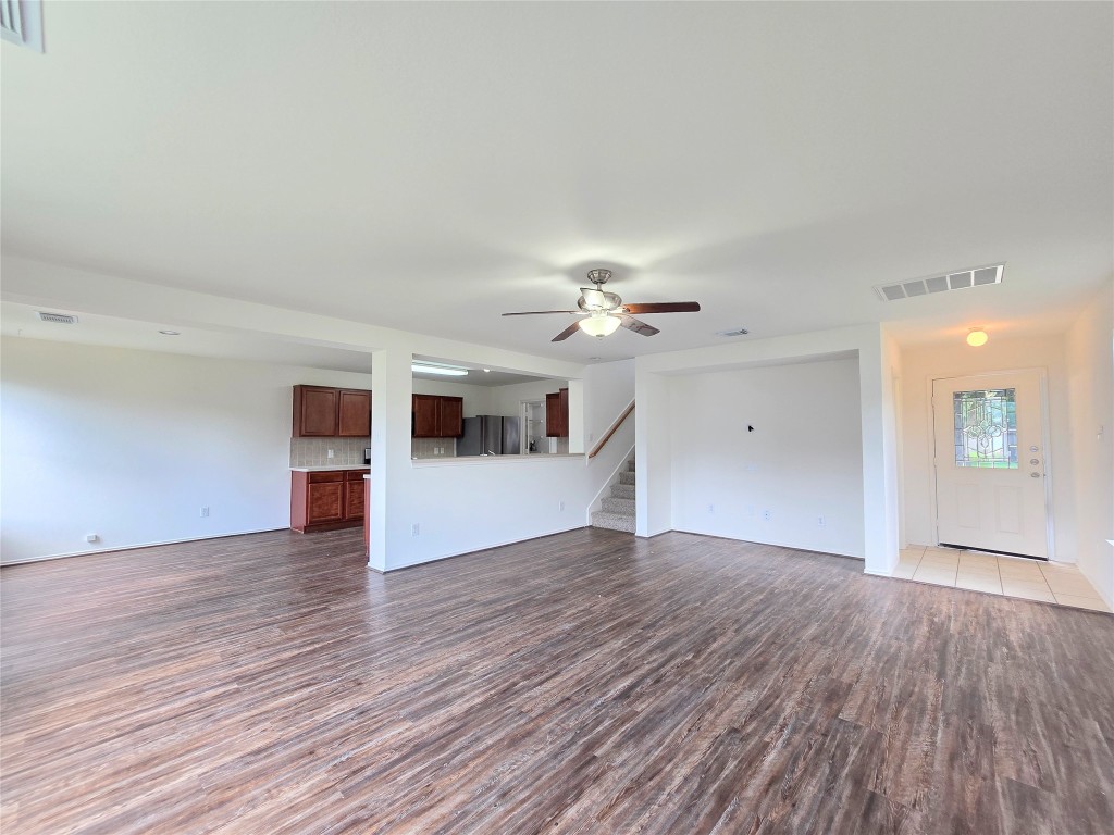 22911 Twisting Maple Court Spring, TX 77373 - Photo 14 of 37 a view of a room with wooden floor and a ceiling fan